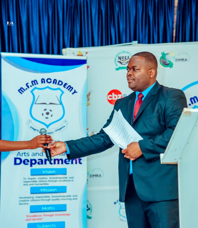 MFM Academy — Presenter holding a certificate