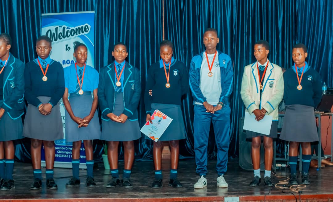 MFM Academy — Learners wearing medals on stage